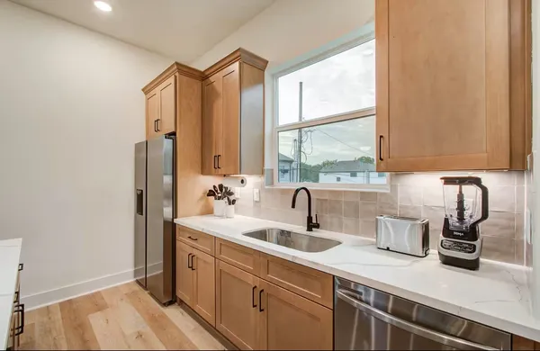 a kitchen with a sink and a window