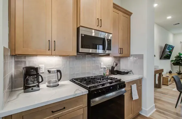 a kitchen with a stove and a microwave