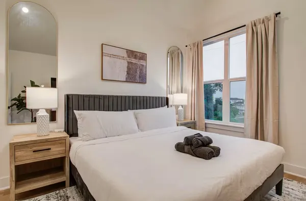 a bedroom with a bed and a window