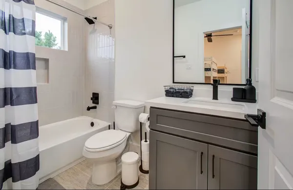 a bathroom with a sink toilet a shower and bathtub