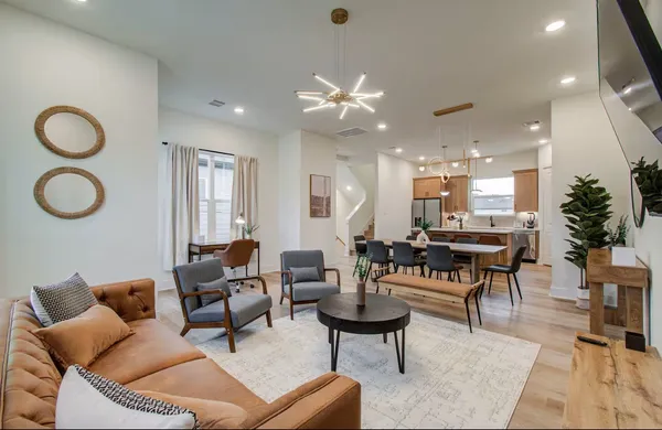 a living room with furniture a rug and a chandelier