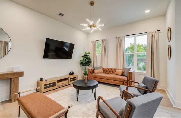 a living room with furniture and a flat screen tv