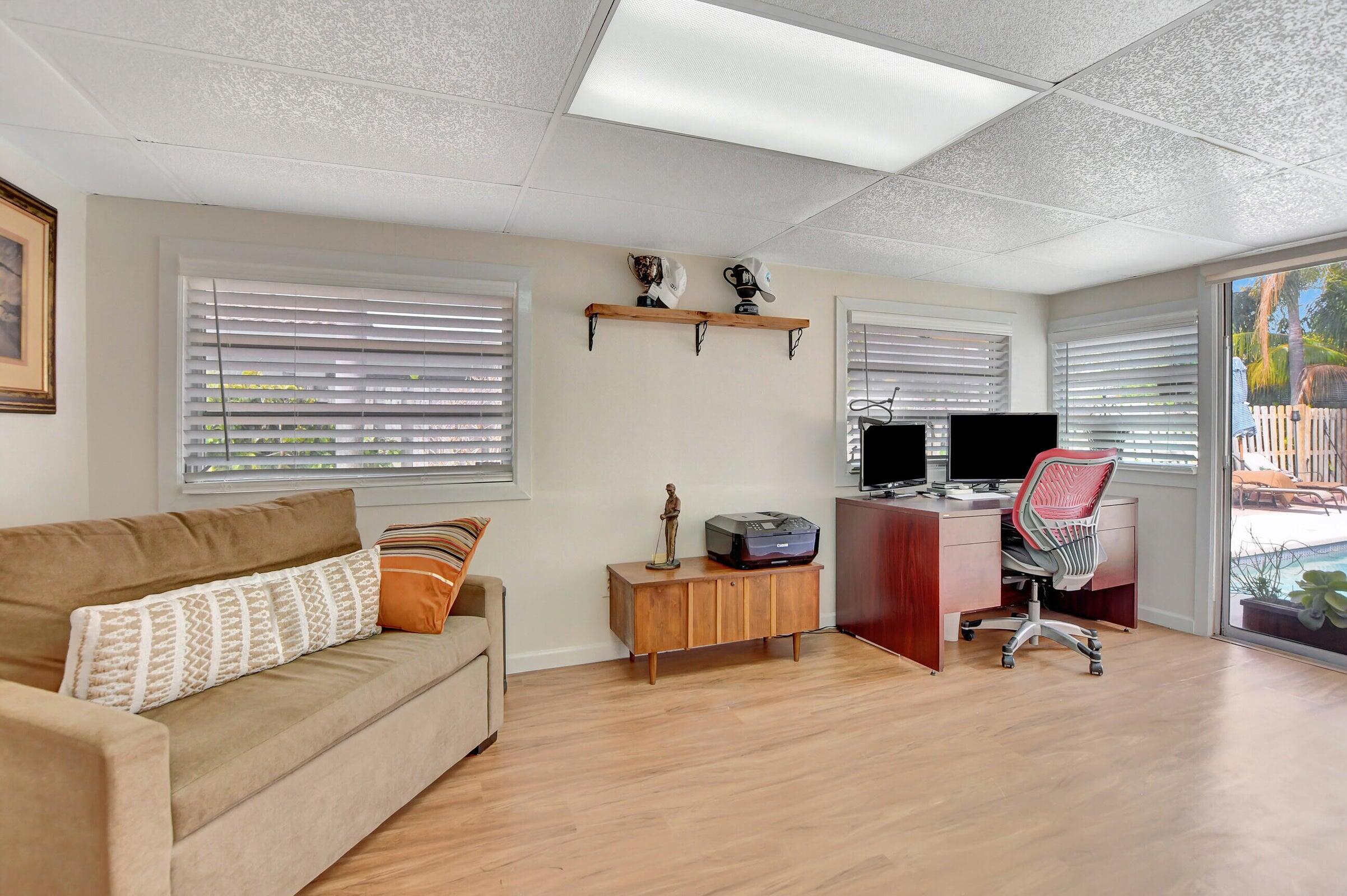 1599 Isabel Este Road Boca Raton, FL 33486 - Photo 16 of 22 a living room with furniture and a window