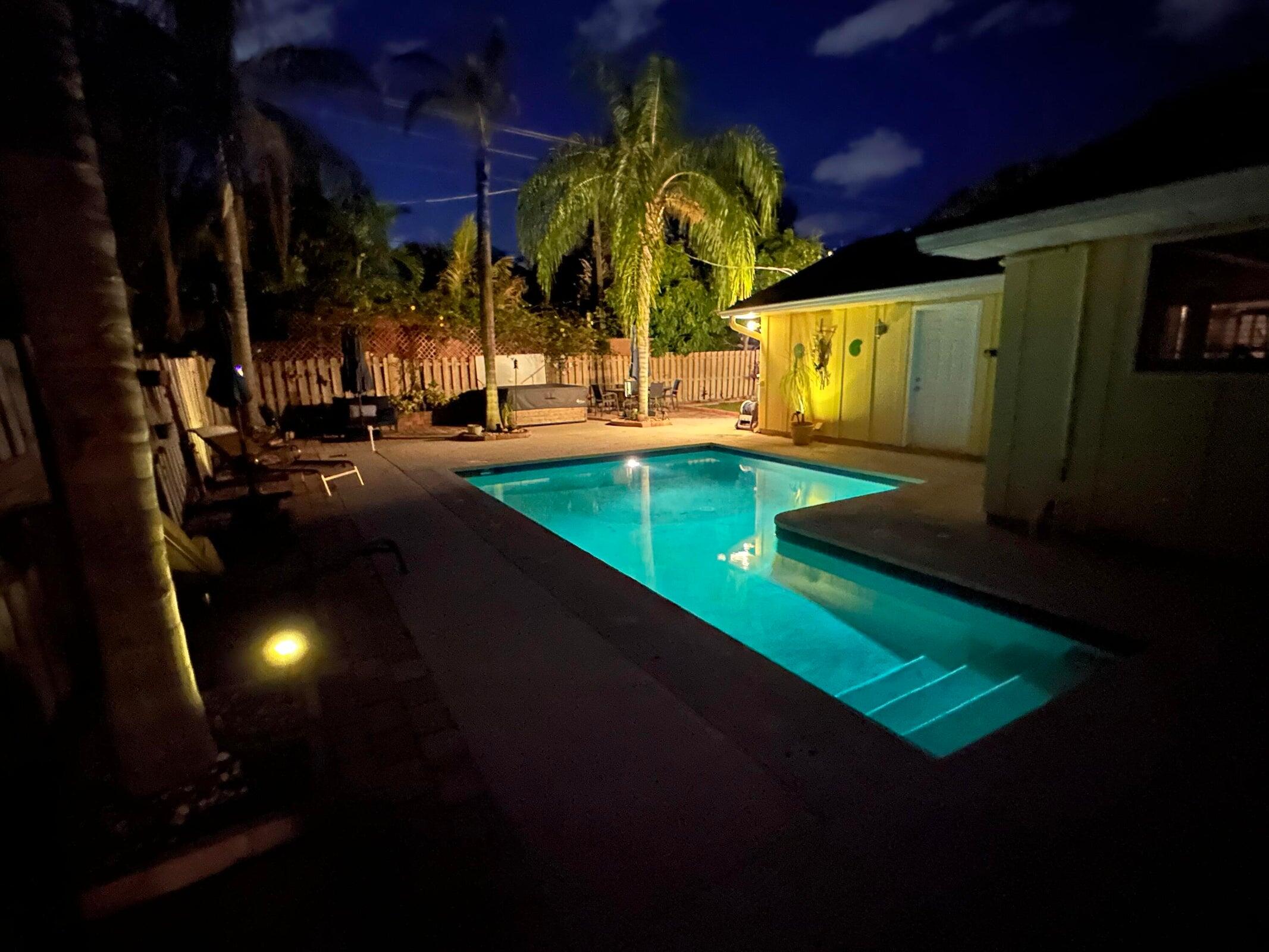 1599 Isabel Este Road Boca Raton, FL 33486 - Photo 18 of 22 a view of a backyard with swimming pool