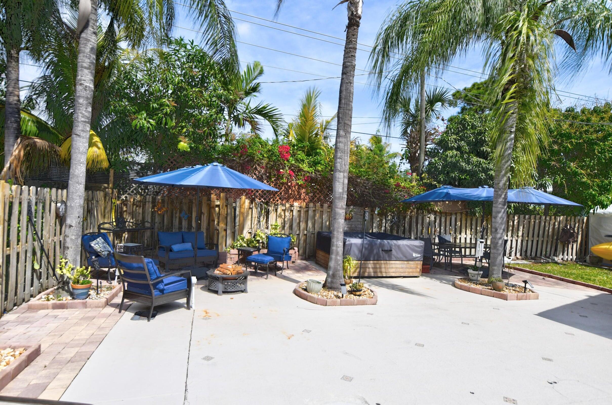 1599 Isabel Este Road Boca Raton, FL 33486 - Photo 21 of 22 a view of the patio with a table and chairs under an umbrella