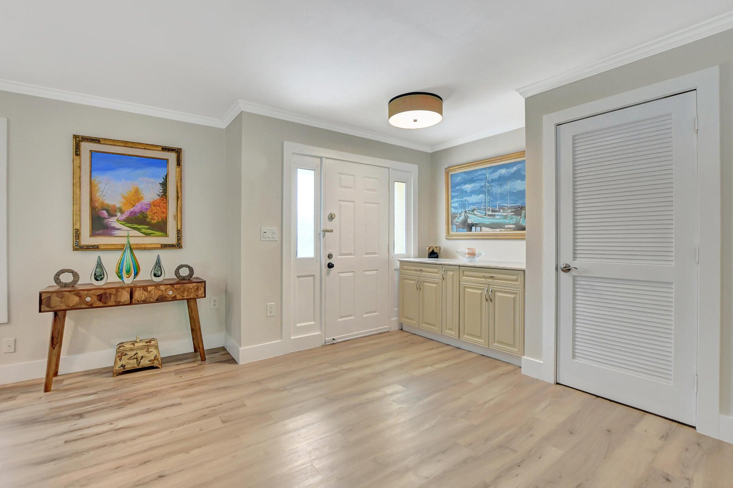 1599 Isabel Este Road Boca Raton, FL 33486 - Photo 10 of 22 a view of a kitchen with wooden floor and a window