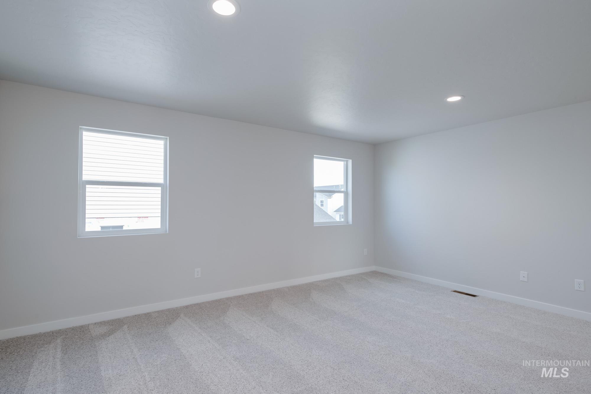 3089 South Maple Rnch Way Nampa, ID 83686 - Photo 16 of 22 Carpeted empty room with recessed lighting and baseboards