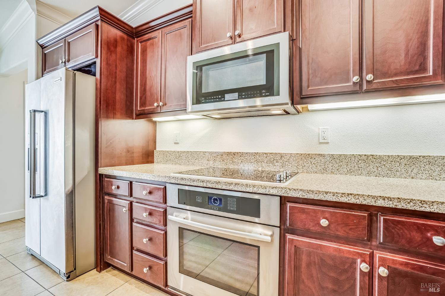 305 Birch Ridge Drive Rio Vista, CA 94571 - Photo 16 of 30 a kitchen with granite countertop a stove microwave and refrigerator