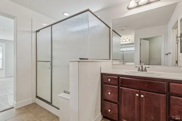 a bathroom with a double vanity sink and mirror