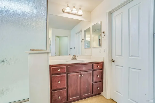 a spacious bathroom with a granite countertop sink a mirror and a