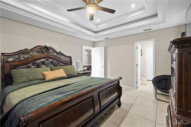 a bedroom with a bed and a ceiling fan