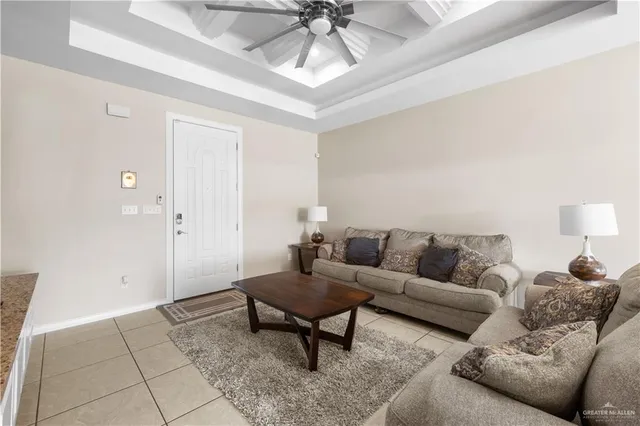 a living room with furniture and a ceiling fan
