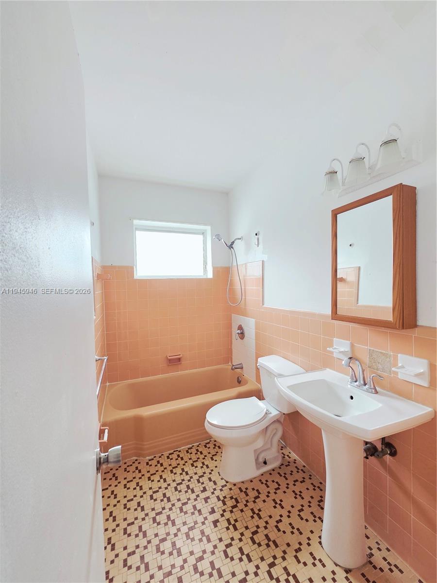 824 82nd Street, Unit 4 Miami Beach, FL 33141 - Photo 13 of 13 a bathroom with a sink toilet a mirror and shower