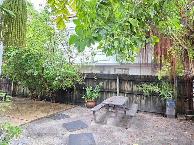a view of a patio with table and chairs and potted plants