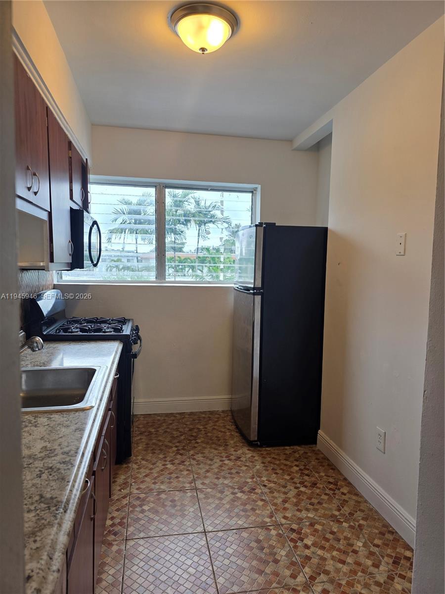824 82nd Street, Unit 4 Miami Beach, FL 33141 - Photo 6 of 13 a kitchen with a refrigerator and a sink