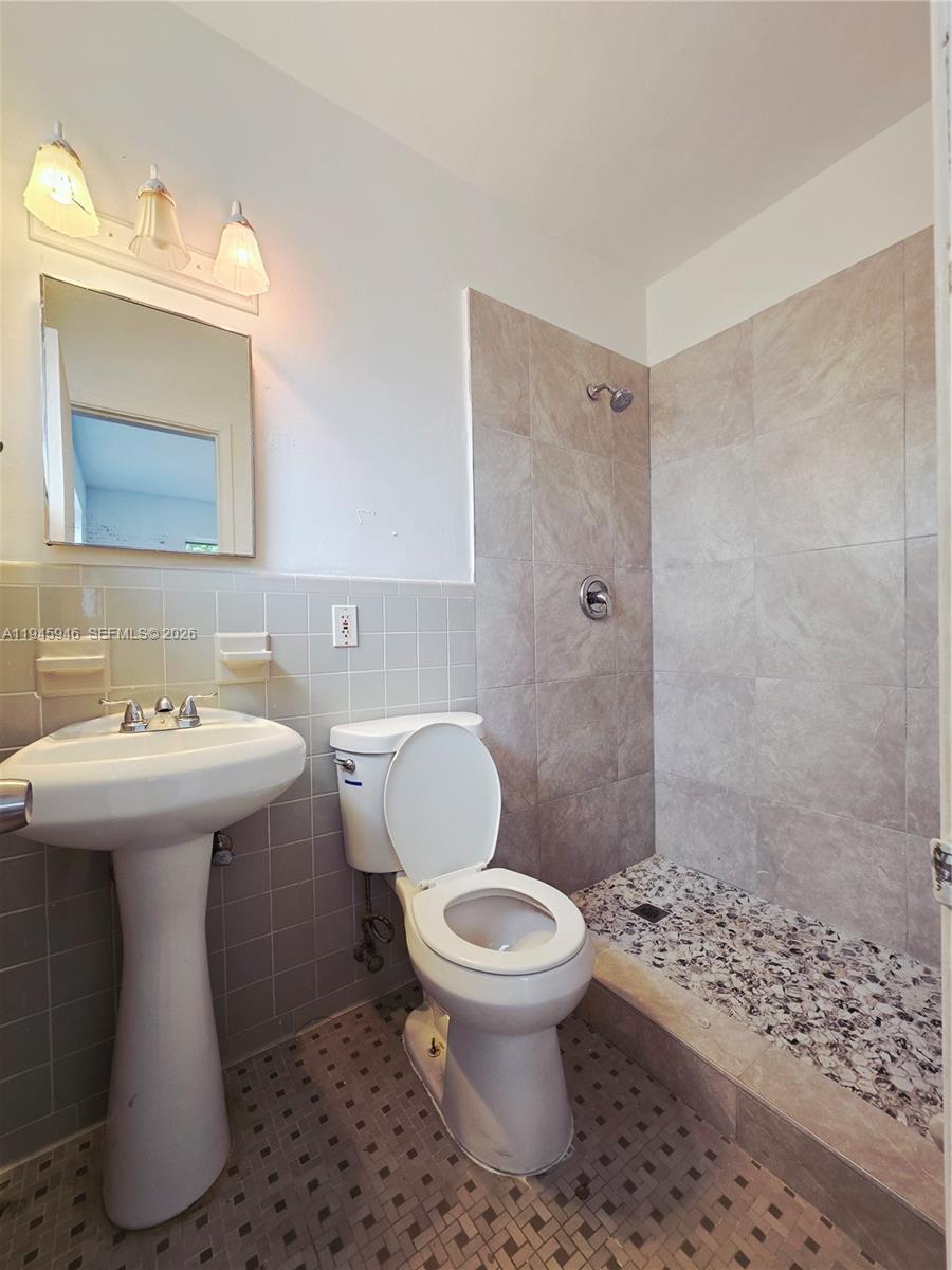 824 82nd Street, Unit 4 Miami Beach, FL 33141 - Photo 10 of 13 a bathroom with a sink toilet and shower