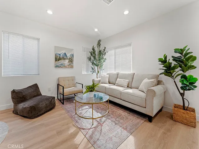 a living room with furniture and a potted plant