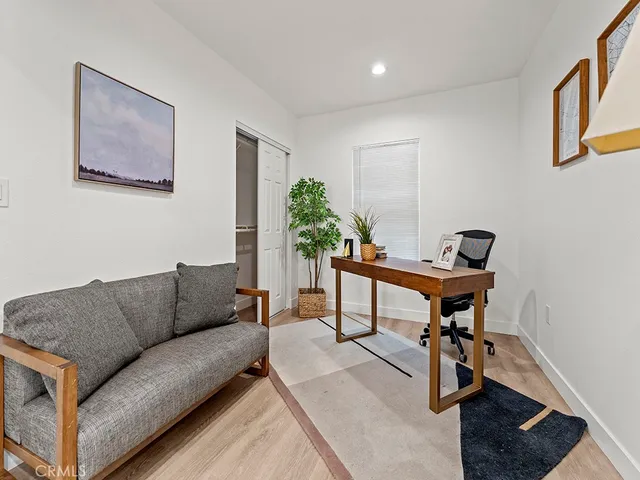 a living room with furniture and a potted plant