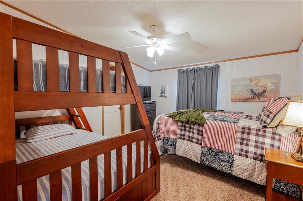 4441 Chapel Road Graham, TX 76450 - Photo 19 of 39 a bedroom with two beds and a wooden floor