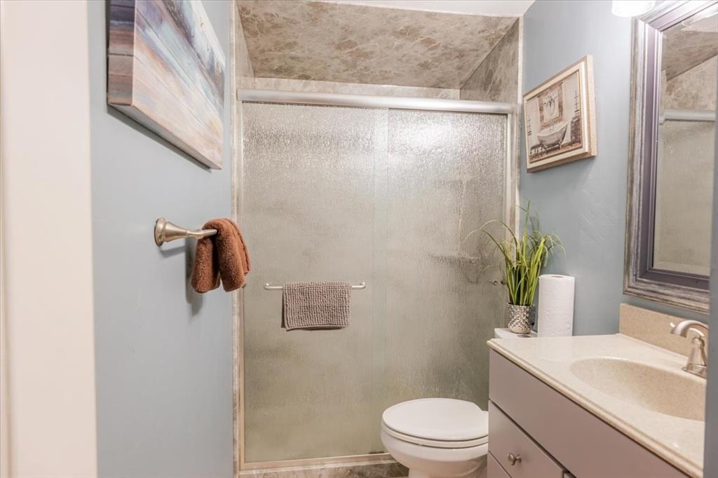 4441 Chapel Road Graham, TX 76450 - Photo 20 of 39 a bathroom with a sink a toilet and shower