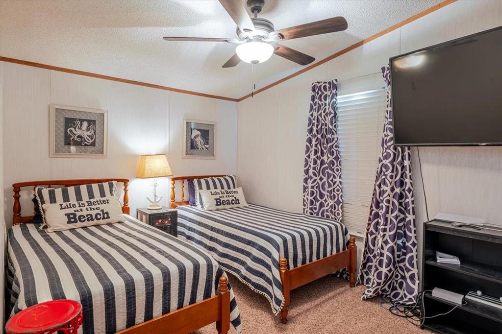 4441 Chapel Road Graham, TX 76450 - Photo 21 of 39 a bedroom with a bed and a chandelier