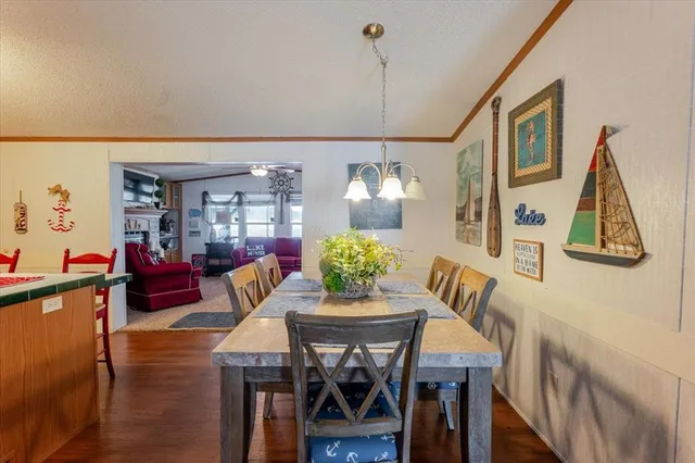 a kitchen with kitchen island granite countertop a sink appliances cabinets and a counter top space