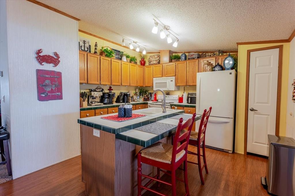 4441 Chapel Road Graham, TX 76450 - Photo 26 of 39 a table and chairs sitting in a kitchen next to a window
