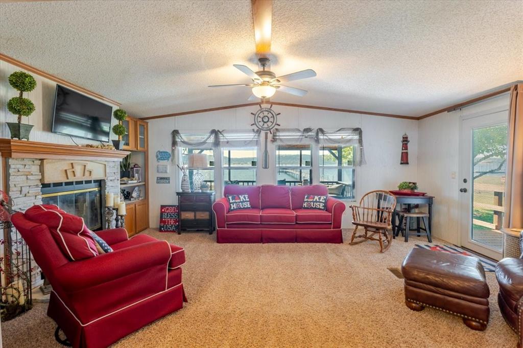 4441 Chapel Road Graham, TX 76450 - Photo 27 of 39 a living room with furniture a fireplace and a chandelier