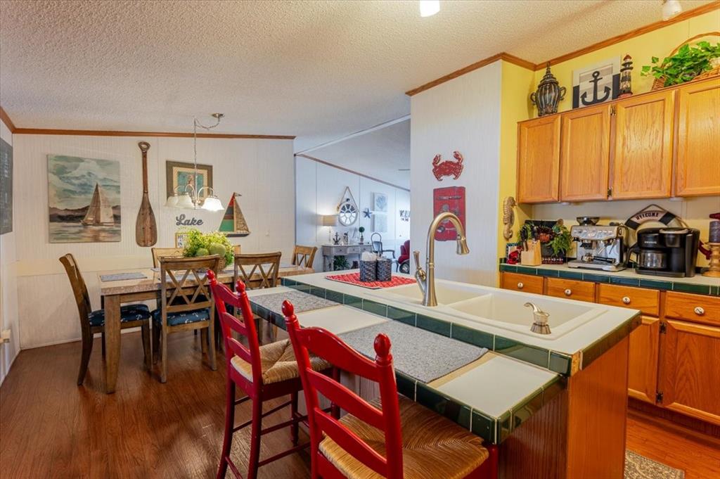 4441 Chapel Road Graham, TX 76450 - Photo 28 of 39 a dining hall with a dining table and chairs with wooden floor