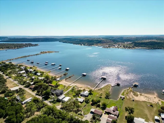 an aerial view of a house with a garden and lake view
