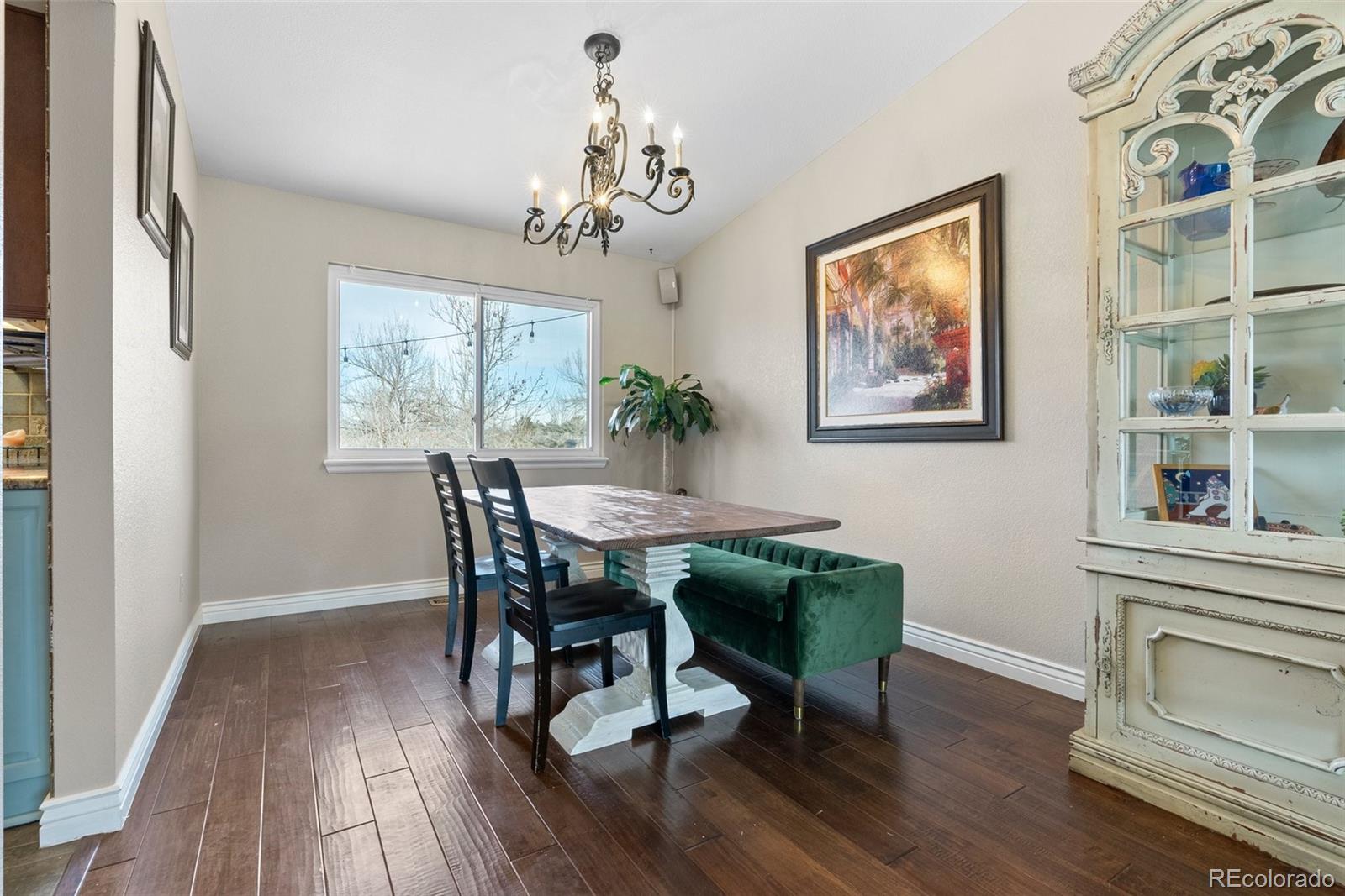 87 Prairie Ridge Road Highlands Ranch, CO 80126 - Photo 8 of 40 a view of a dining room with furniture wooden floor and a chandelier