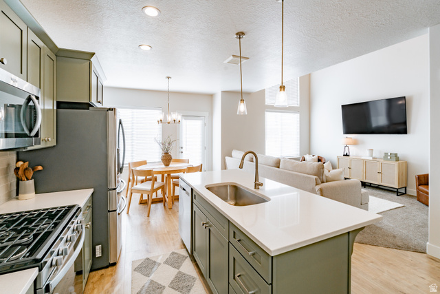 4881 Heartwood Road Mapleton, UT 84664 - Photo 6 of 25 Open concept living space featuring a kitchen island with sink, stainless steel appliance