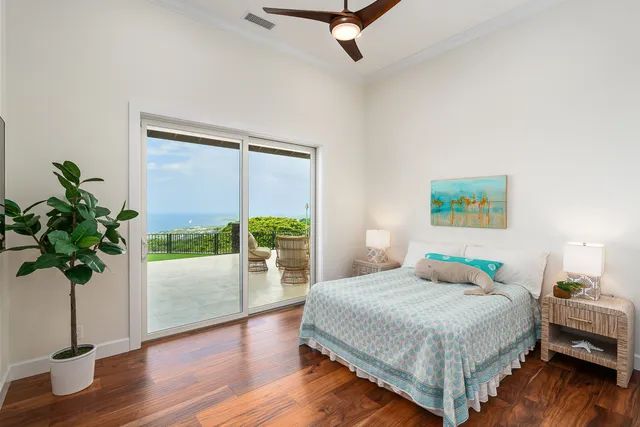 a bedroom with a bed and a potted plant