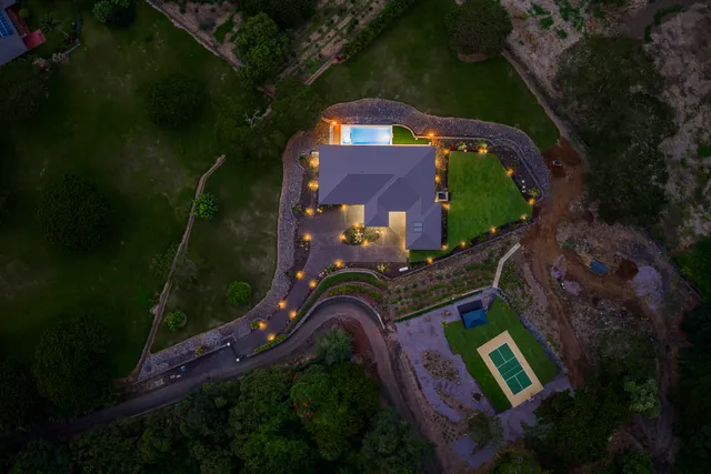 an aerial view of a house swimming pool outdoor seating and yard
