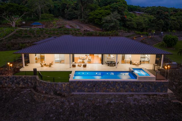a view of a yard with table and chairs under an umbrella