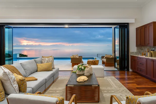 a living room with furniture and a floor to ceiling window