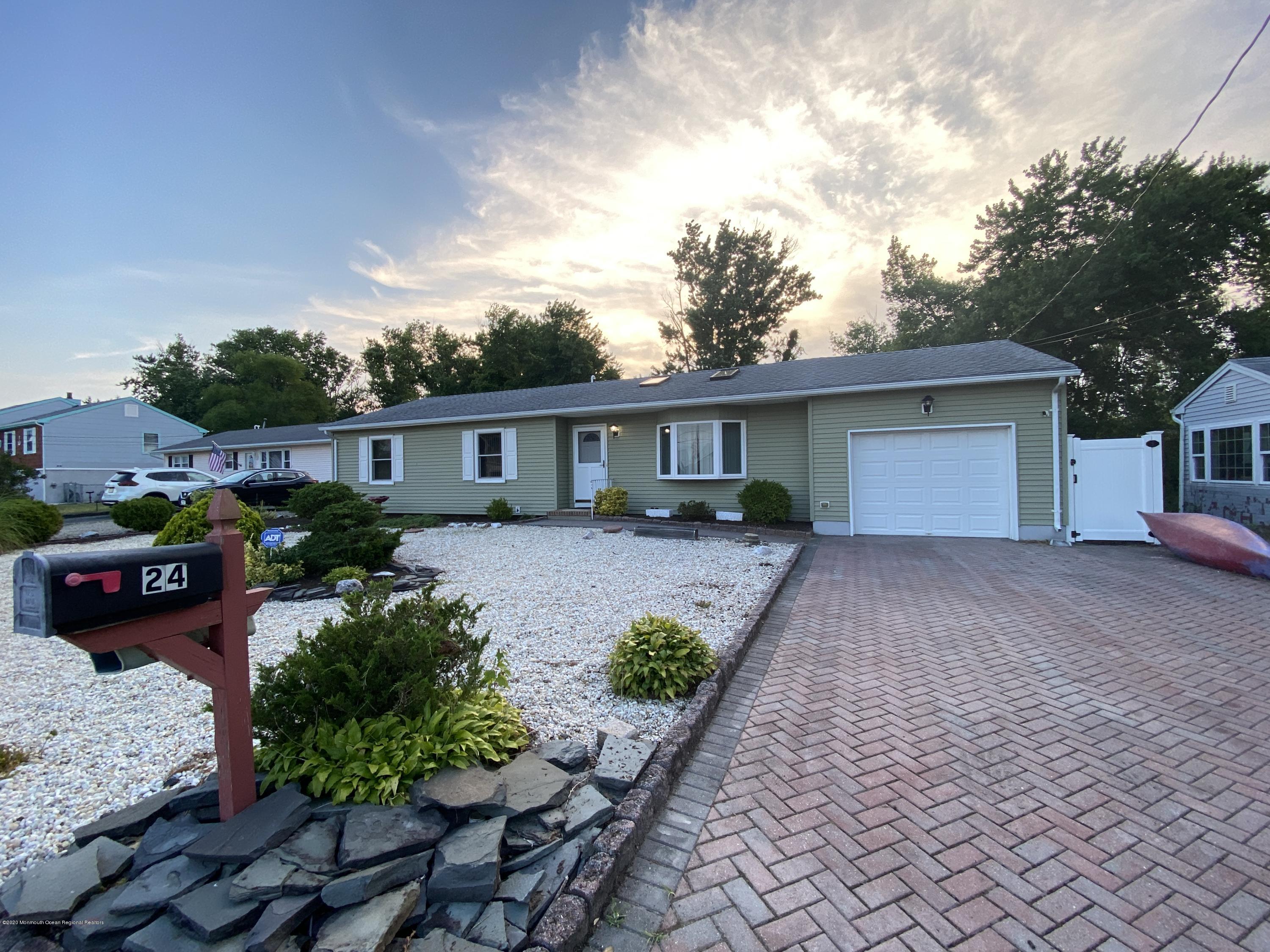 24 Cross Trees Road Brick, NJ 08723 - Photo 1 of 13 a front view of a house with a yard and potted plants