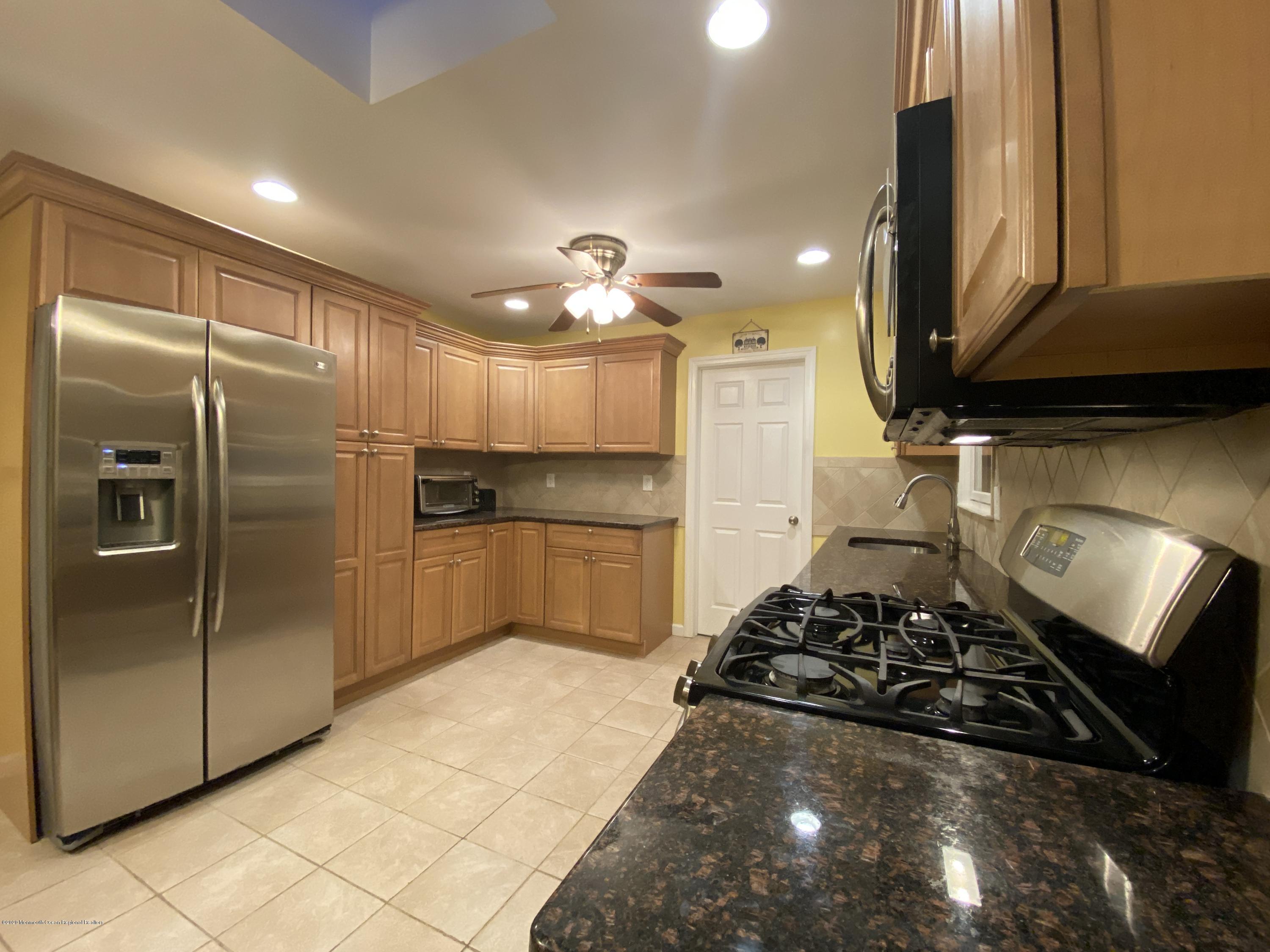 24 Cross Trees Road Brick, NJ 08723 - Photo 6 of 13 a kitchen with stainless steel appliances granite countertop a stove a refrigerator and a sink