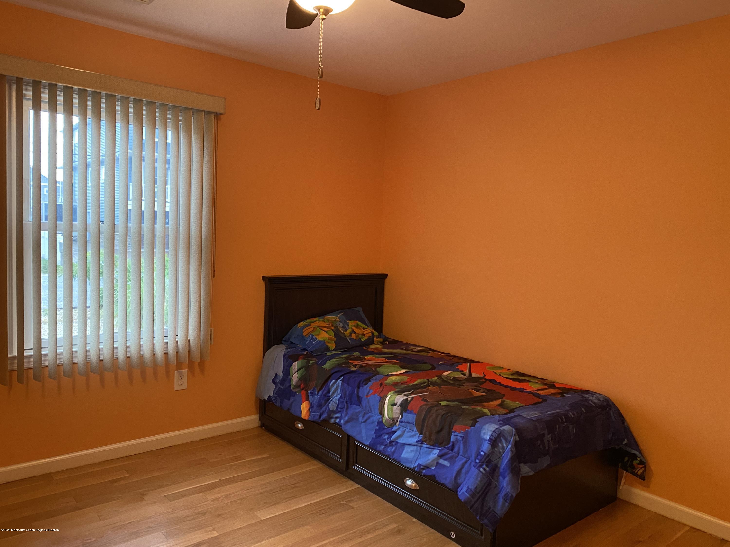 24 Cross Trees Road Brick, NJ 08723 - Photo 8 of 13 a bed sitting in a bedroom next to a window