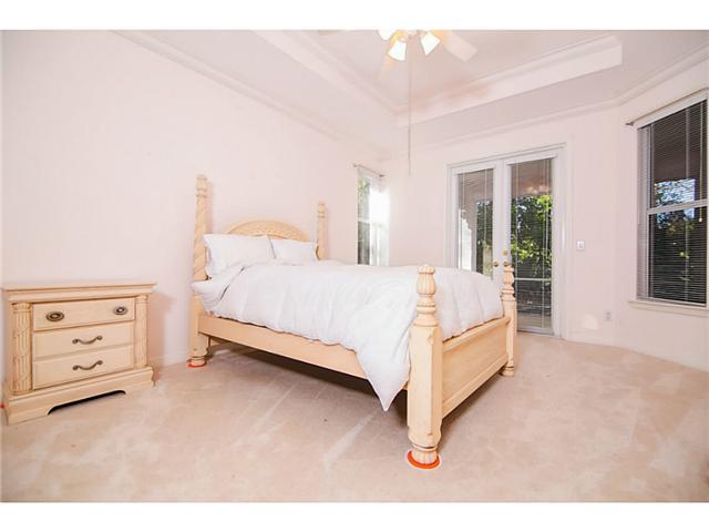 2677 Southwest Oak Ridge Road Palm City, FL 34990 - Photo 19 of 25 a bedroom with a bed and a cabinets
