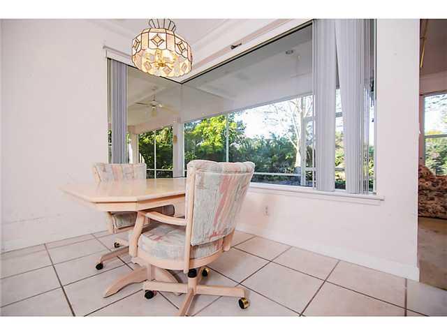 2677 Southwest Oak Ridge Road Palm City, FL 34990 - Photo 20 of 25 a view of a dining room with furniture window and outside view