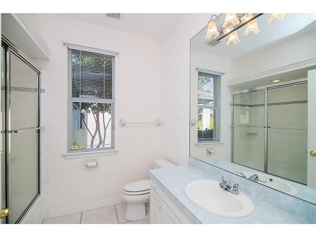 2677 Southwest Oak Ridge Road Palm City, FL 34990 - Photo 21 of 25 a bathroom with a toilet a sink and mirror