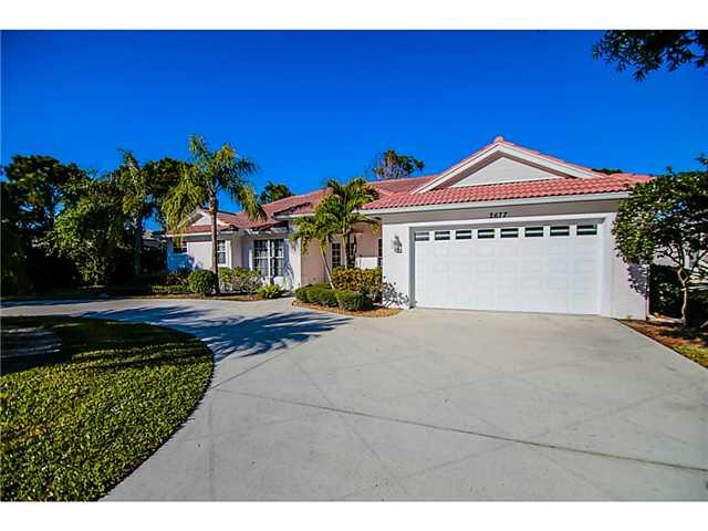 2677 Southwest Oak Ridge Road Palm City, FL 34990 - Photo 24 of 25 a front view of a house with a yard