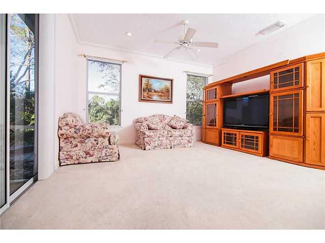 2677 Southwest Oak Ridge Road Palm City, FL 34990 - Photo 3 of 25 a living room with a flat screen tv and a lamp