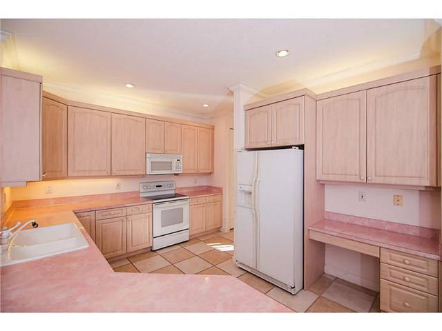 2677 Southwest Oak Ridge Road Palm City, FL 34990 - Photo 6 of 25 a kitchen with granite countertop white cabinets and refrigerator