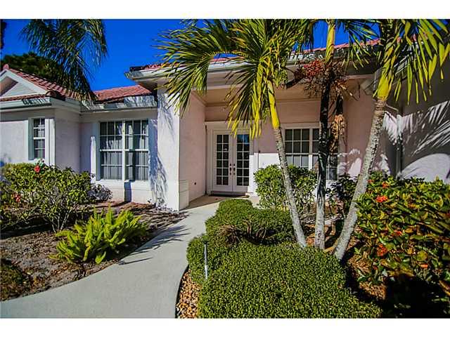 2677 Southwest Oak Ridge Road Palm City, FL 34990 - Photo 10 of 25 a view of a house with a flower garden