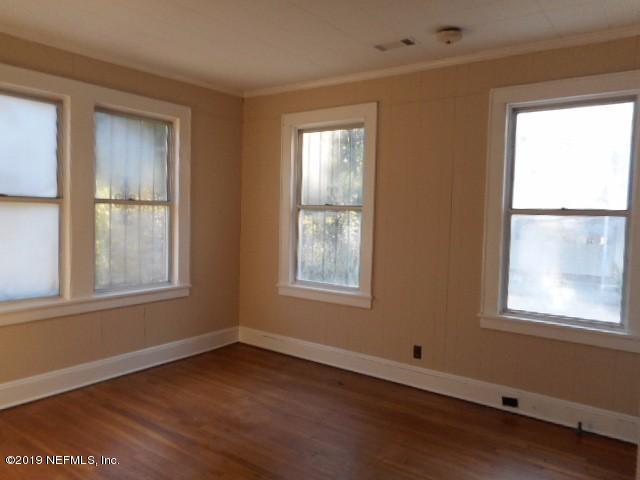 3359 Norman Bridge Road Montgomery, AL 36105 - Photo 4 of 10 a view of an empty room with wooden floor and windows