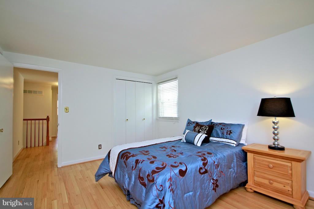 8200 Burnley Road Baltimore, MD 21204 - Photo 15 of 21 a bedroom with a bed and a flat tv screen on a dresser