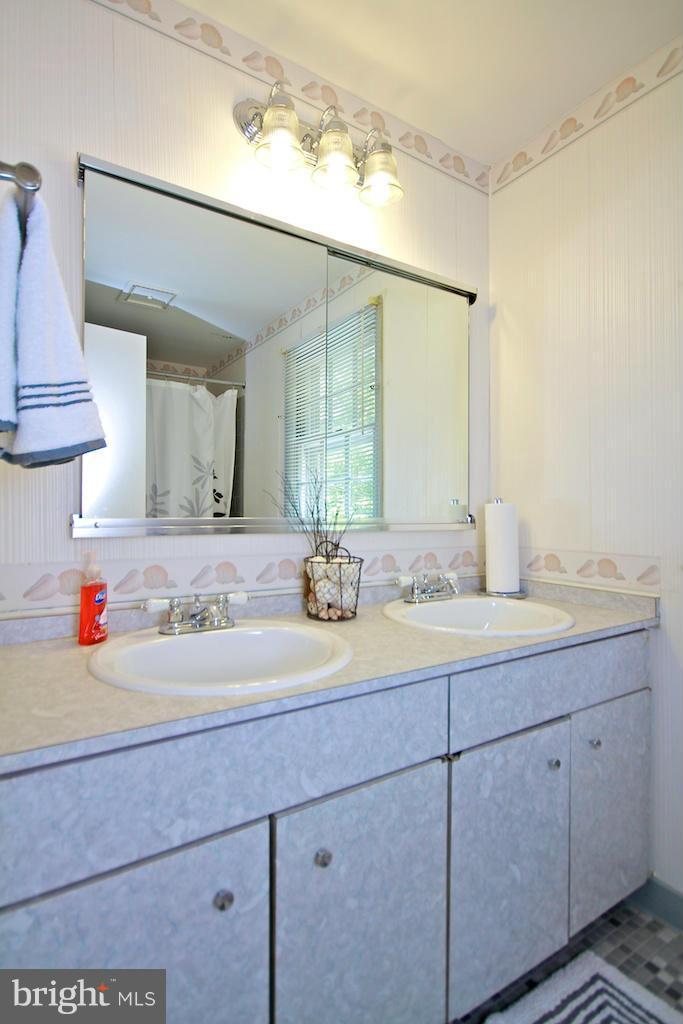 8200 Burnley Road Baltimore, MD 21204 - Photo 17 of 21 a bathroom with a sink and a mirror