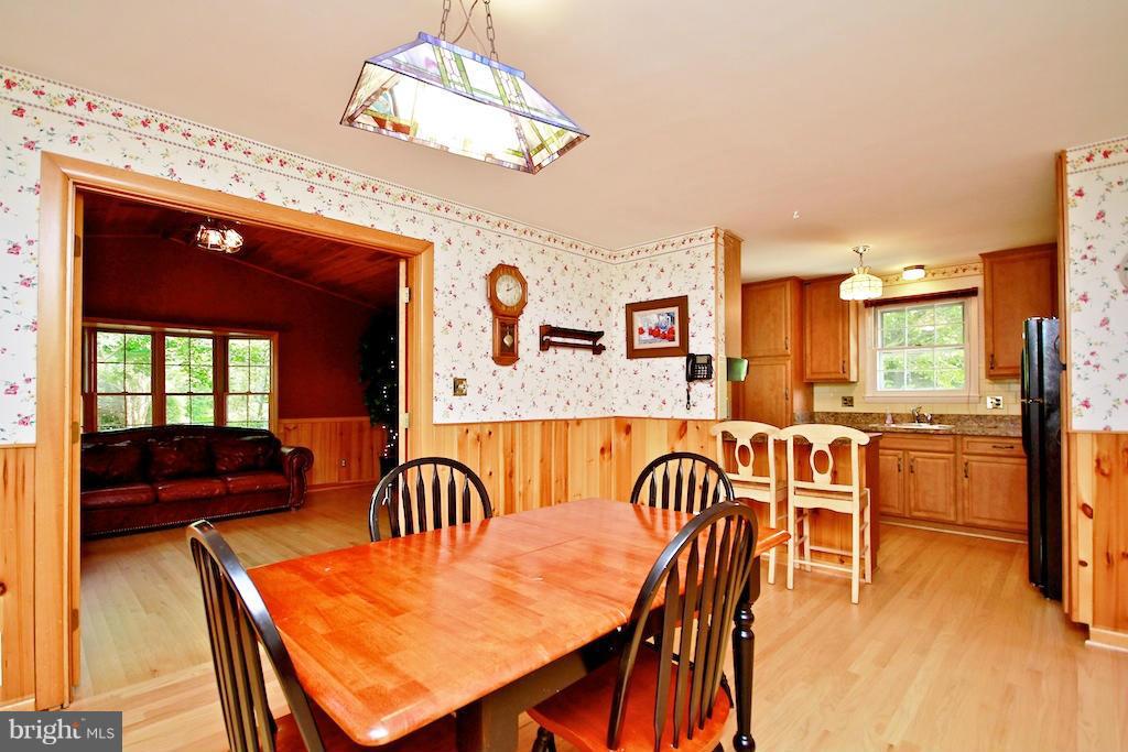 8200 Burnley Road Baltimore, MD 21204 - Photo 4 of 21 a dining room with furniture a chandelier and wooden floor